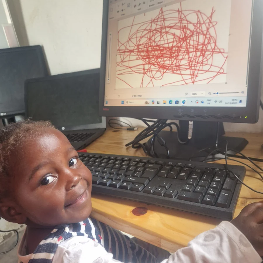 Child smiling at the computer